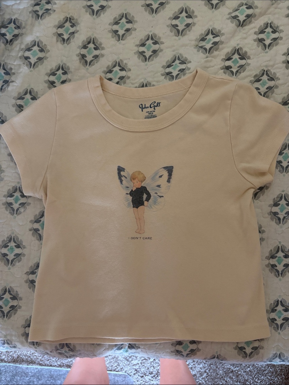 Brandy Melville Cream Tee with Fairy Graphic and Navy Wing Accents